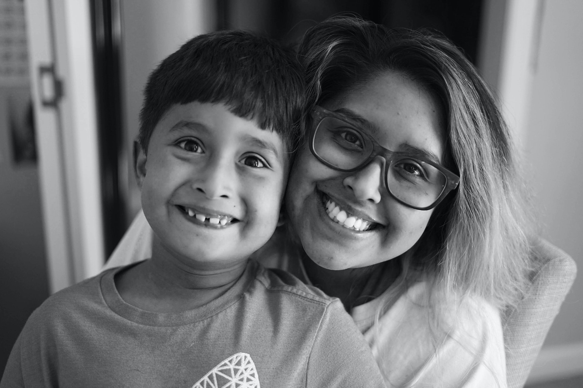 a woman and a boy are posing for a picture