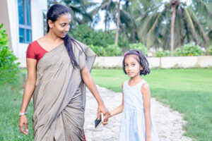 a woman and a little girl holding hands