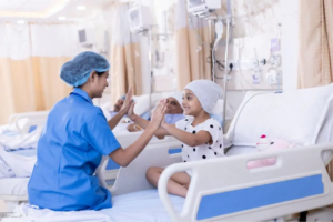 a woman in a blue shirt and a child in a hospital bed