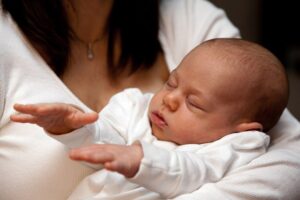 a woman holding a baby in her arms