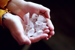 a person holding a handful of crystals in their hands