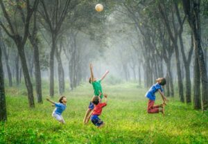 a group of young children playing a game of frisbee