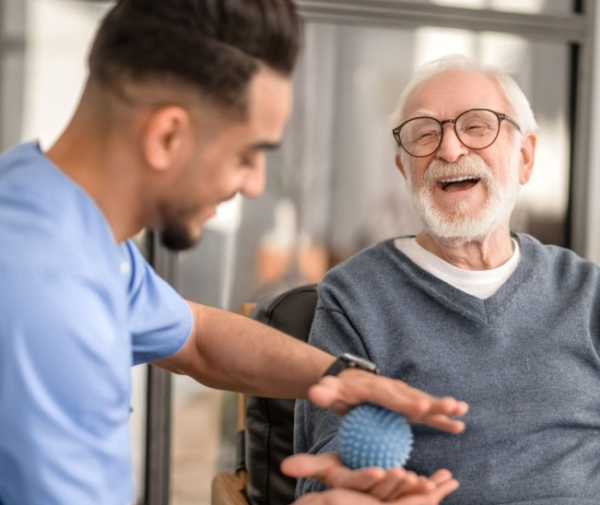 A VCCC doctor is treating an old patient.