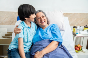 a woman hugging a boy in a hospital bed