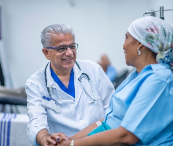 a doctor talking to a patient in a chair