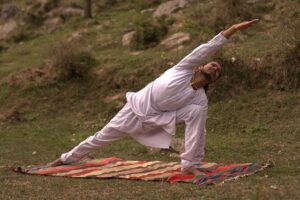 a man doing a yoga pose on a blanket